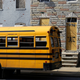 A student walks past vacant row houses to a waiting school bus as school gets out for the day in Baltimore (April 9, 2013)